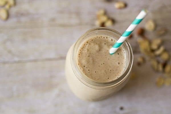 Smoothie in mason jar with aqua blue straw coffee and oat smoothie
