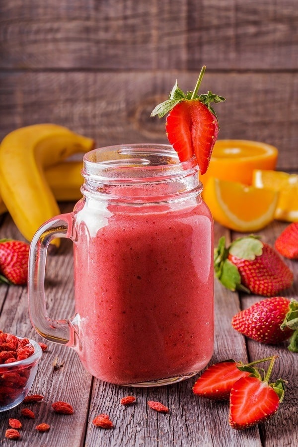 Blended smoothie with ingredients. strawberry smoothie with orange juice